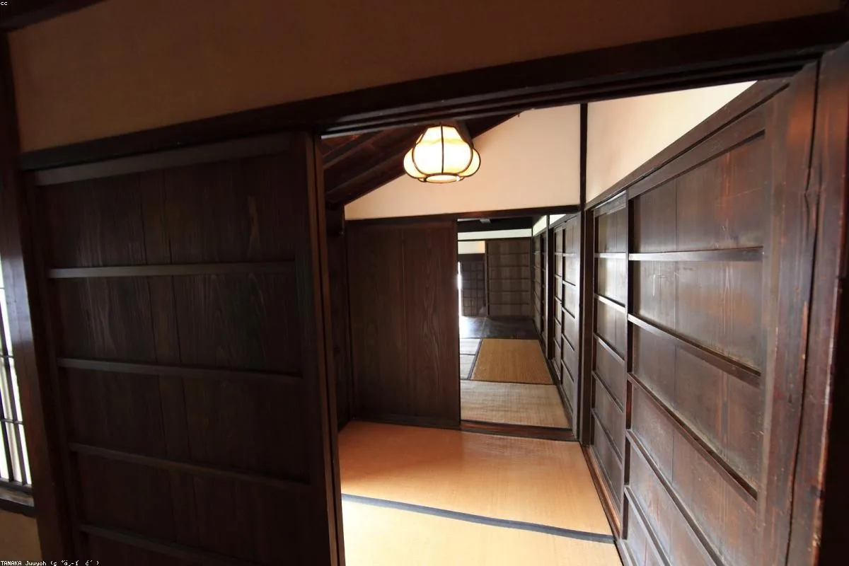 Tatami room with sliding shoji doors and a paper lamp