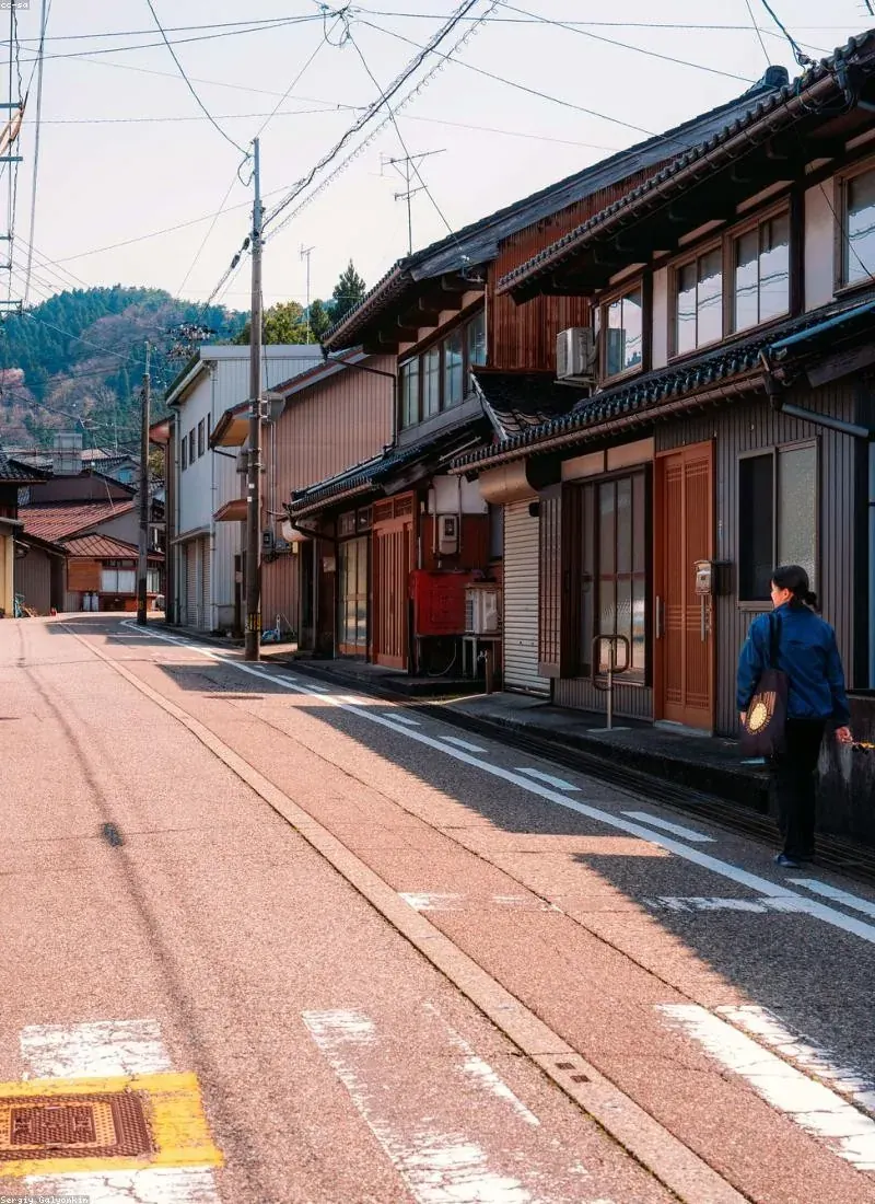 Old merchant street of wooden houses with tram tracks